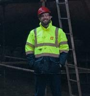 Photo of apprentice Daryn McGarrigle in front of his ship. 