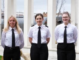 Three female cadets pose outside Riverside campus 
