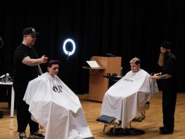 Barber.josh.o.p trainers demonstrating cutting techniques on stage at City campus 