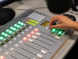 Student using sound equipment in studio 