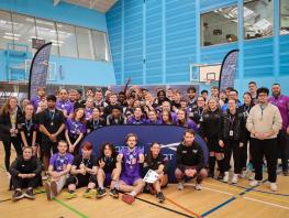 A big group of sports students in the games hall. 