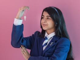 Ashley Tandon winner of the City of Glasgow College Jewellery competition holding her winning pendant. 