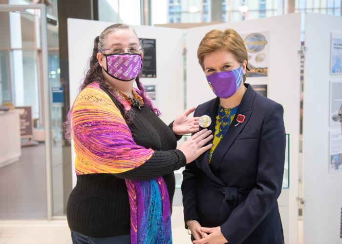 First Minister receives climate change inspired brooch for COP26