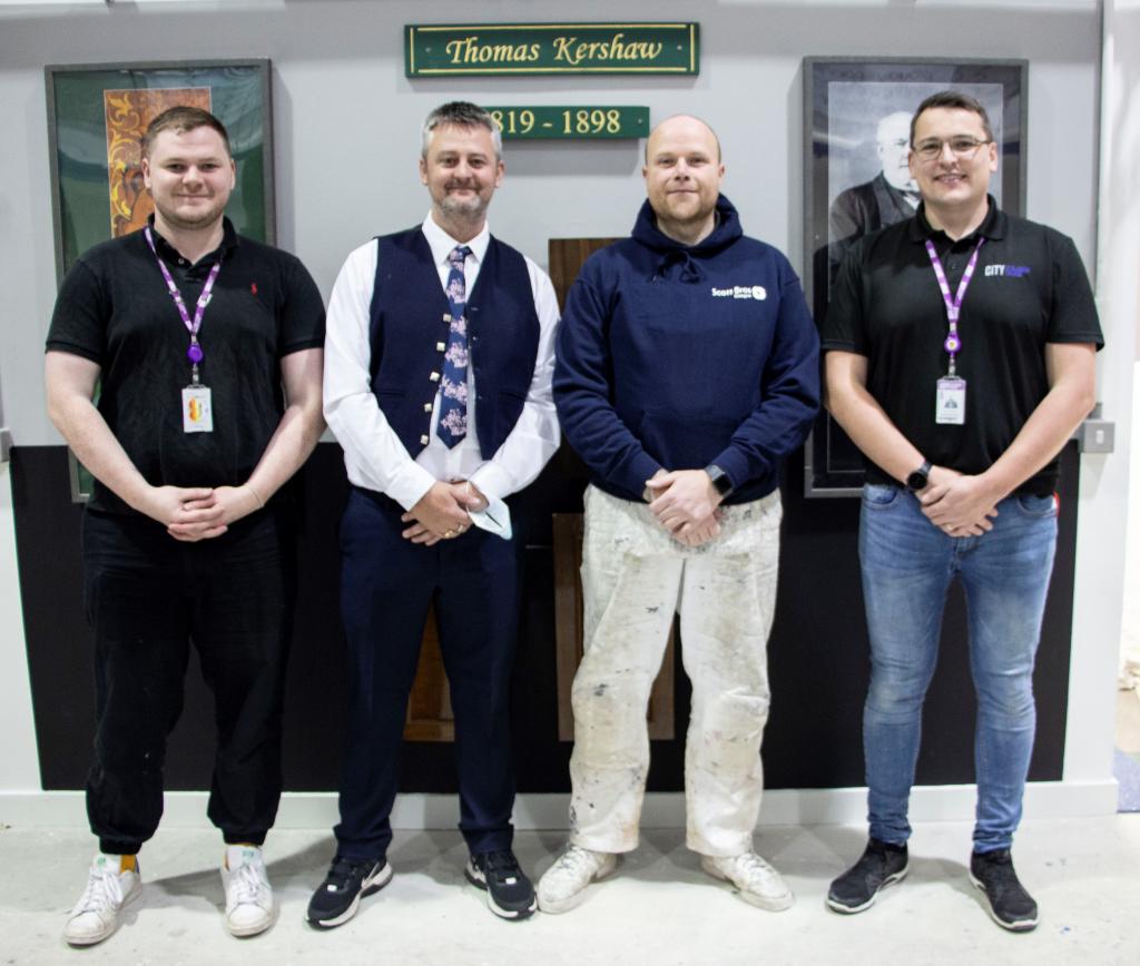 Charlie Kennedy, Andy McNicol, Jaemie Smith, Michael McEwan standing in a line in college construction workshop