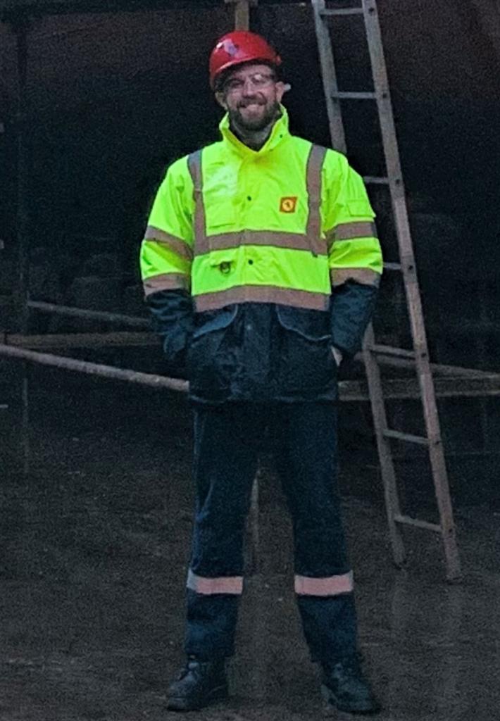 Photo of apprentice Daryn McGarrigle in front of his ship.