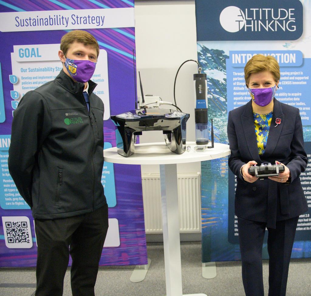 Dale Colley pictured with First Minister holding the Aquabot he invented.