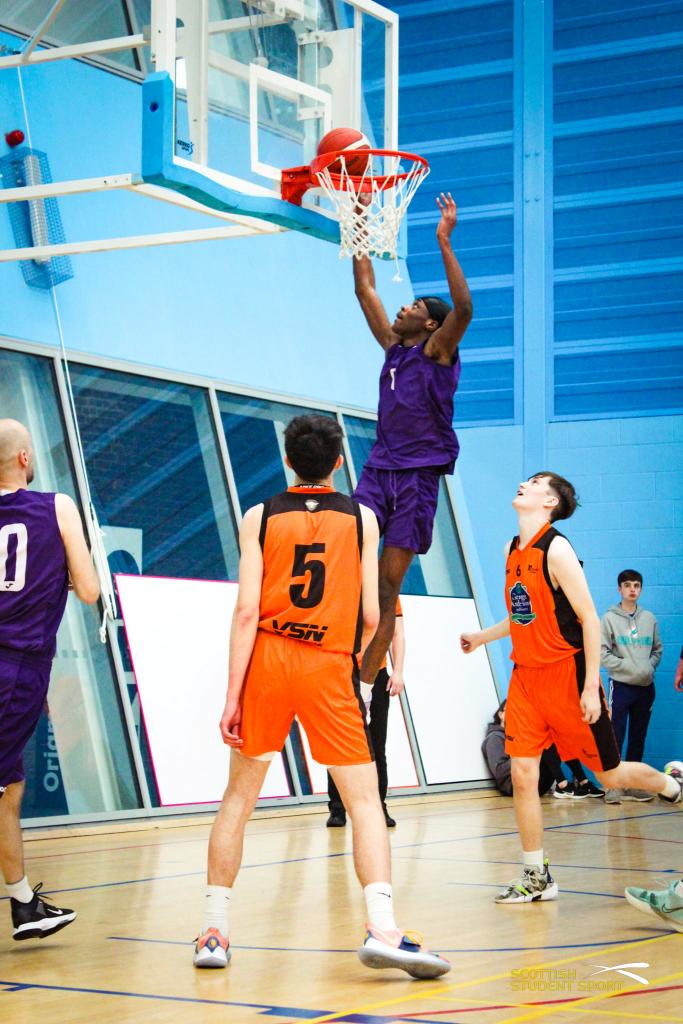 College sports students playing basketball.