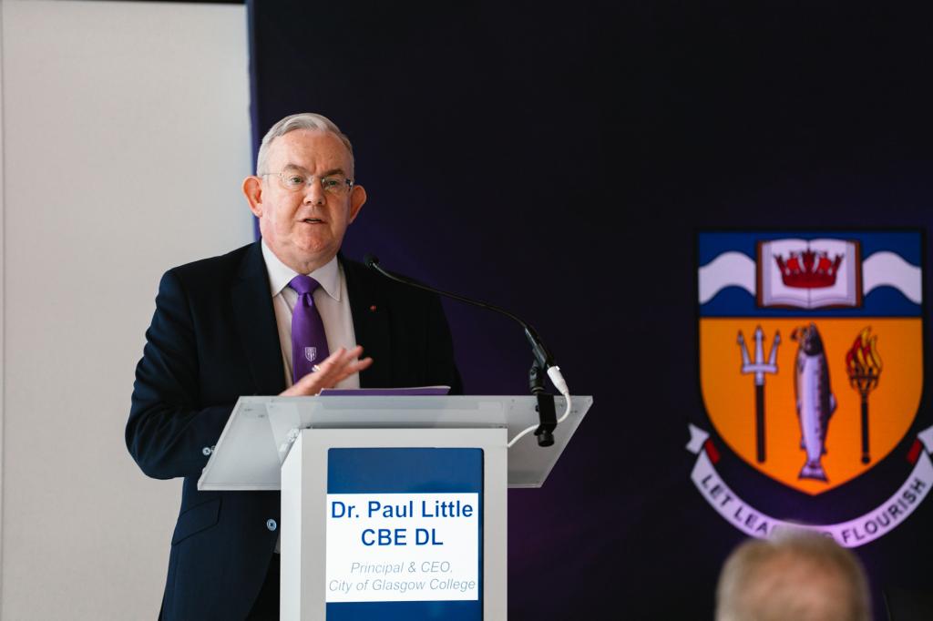 Principal Paul Little, CBE speaking at the lectern during the conference.