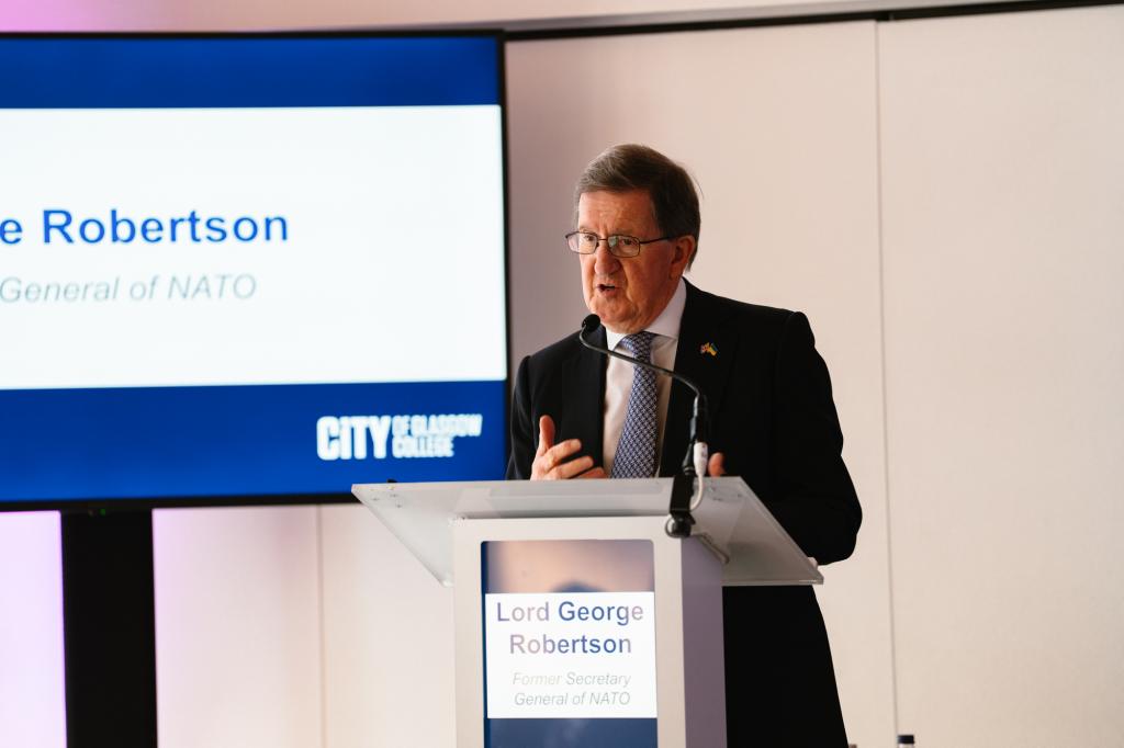 Lord George Robertson, former NATO Secretary General and UK Defence Secretary speaking at the lectern during the conference