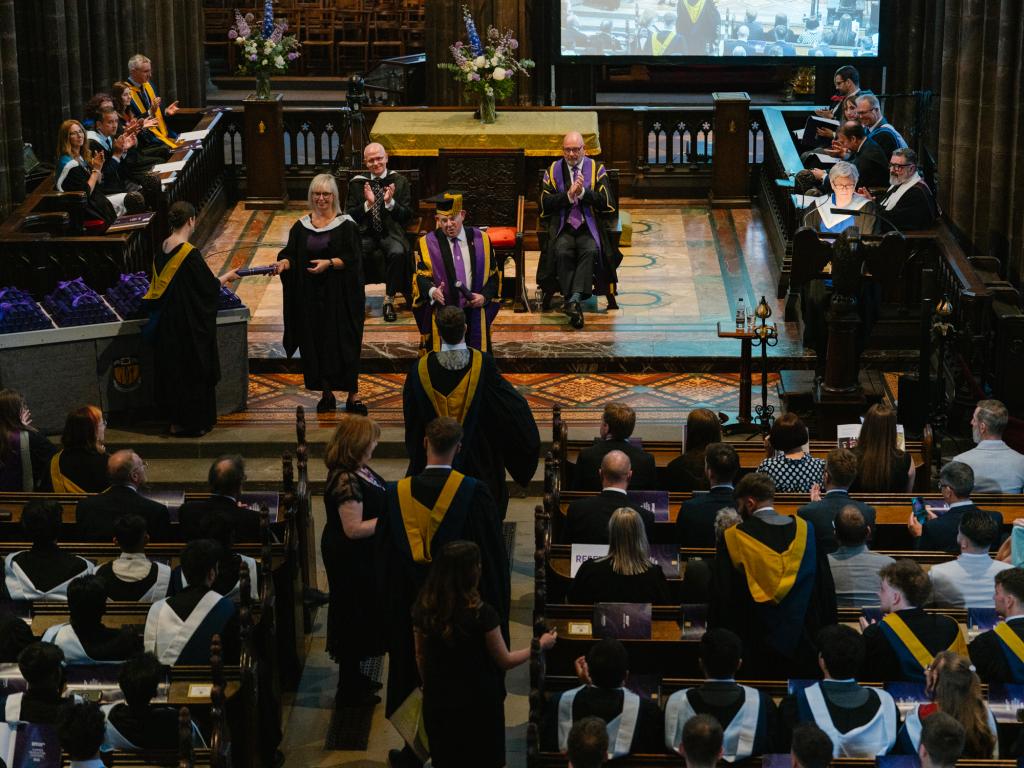 Inside Glasgow Cathedral with students lining up to receive their scroll