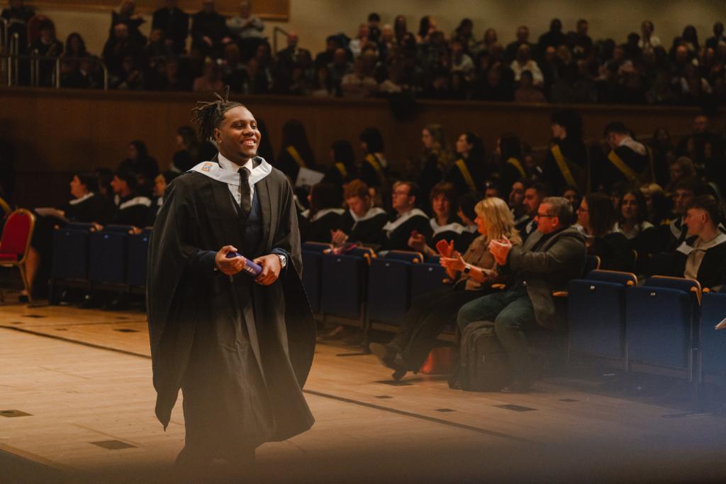 A graduate walking across the stage