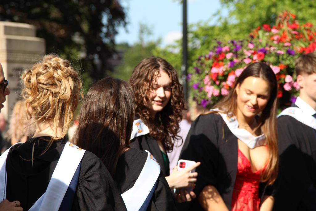 A group of students in graduation gowns outside Glasgow Cathedral