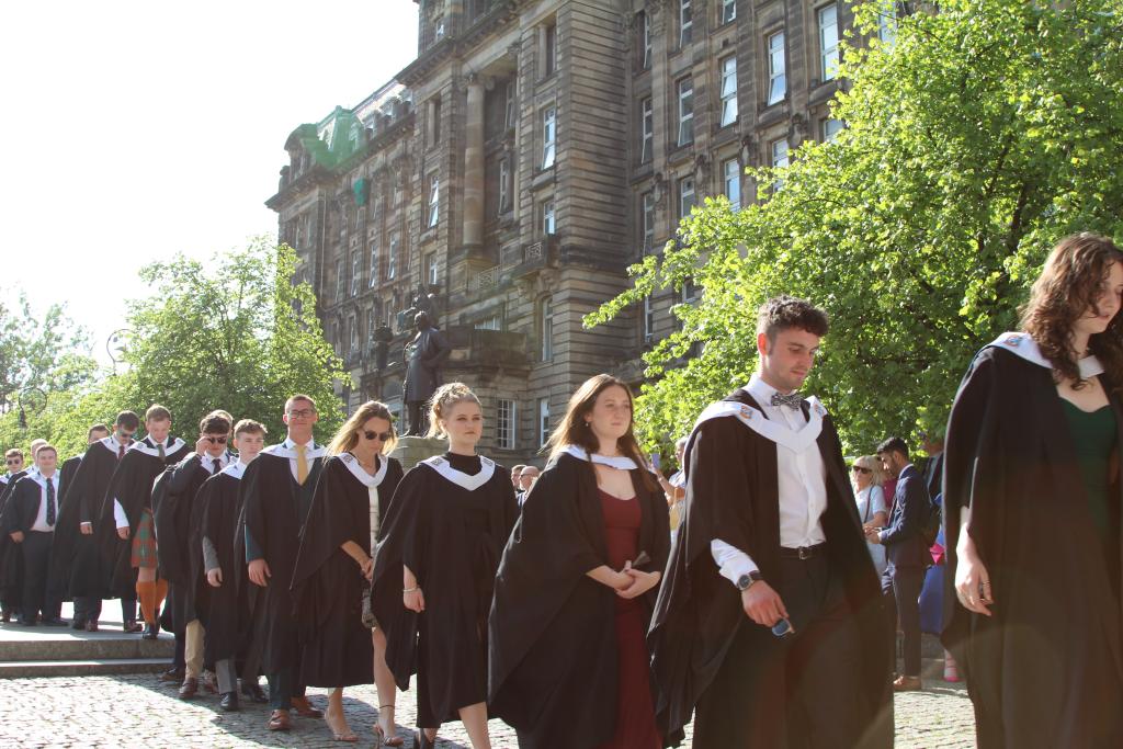 Students lined up walking into Glasgow Cathedral for graduation ceremony.