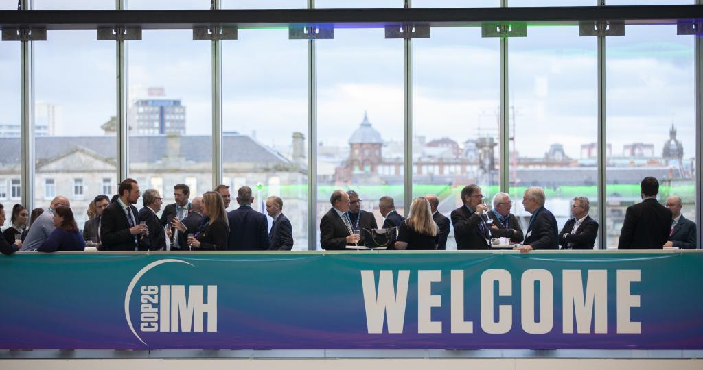 Guests enjoying a drinks reception on balcony at the International Maritime Hub.