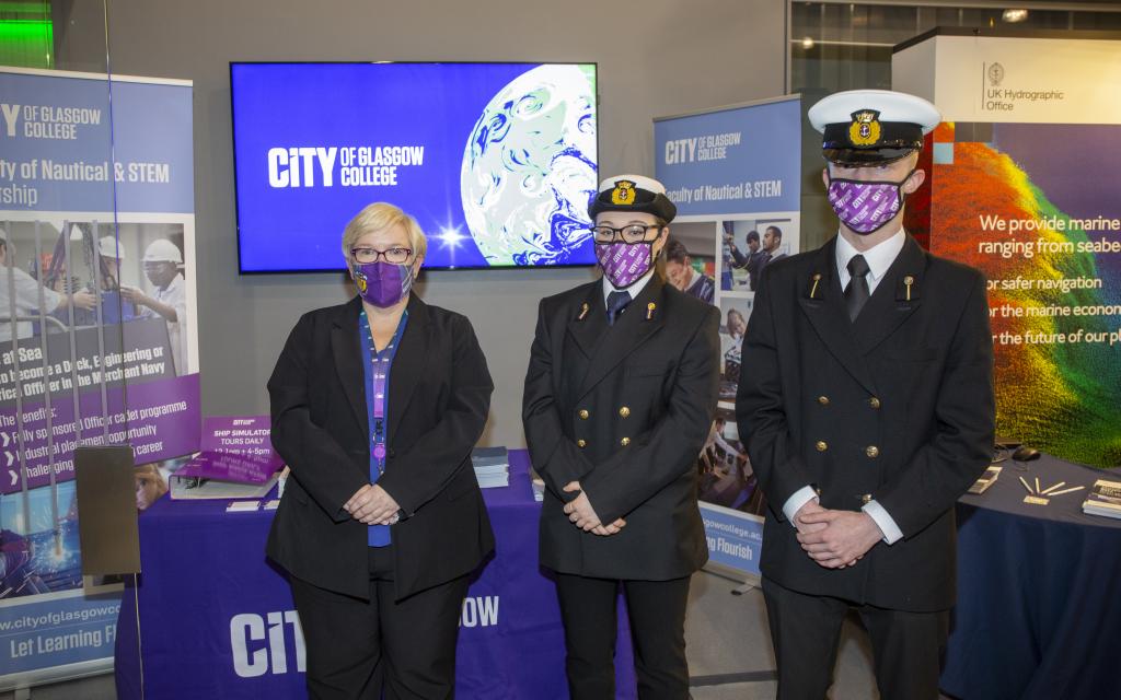 Cadets and Lecturer in front of Faculty of Nautical and STEM exhibition stand.
