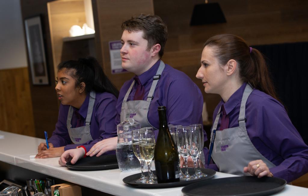 Hospitality students at the bar in Scholars Training Restaurant.