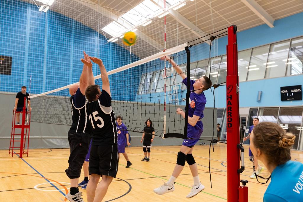 Mens volleyball team in action on the court.