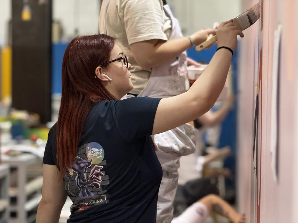 A competing apprentice demonstrates their painting skills.