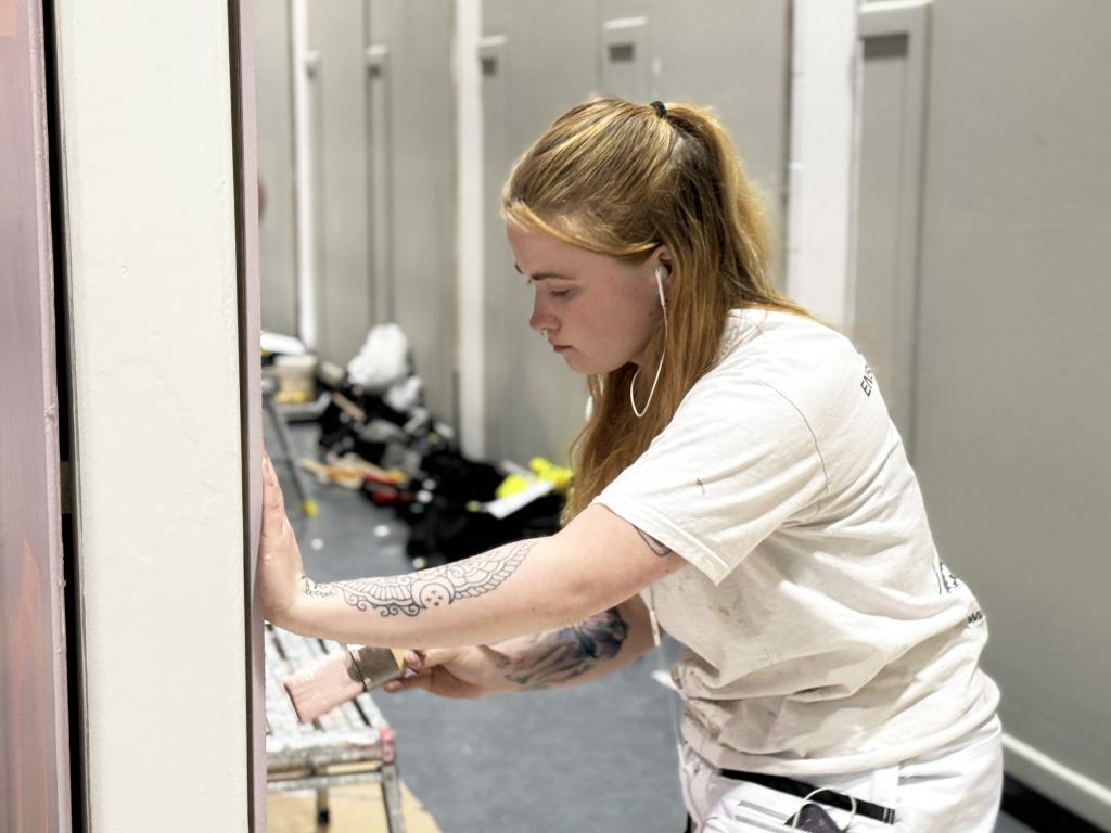 An apprentice demonstrates their painting skills.