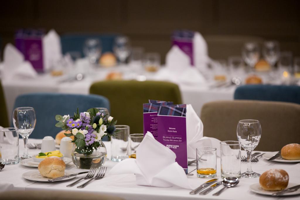 Tables set up for a formal dinner at City of Glasgow College.