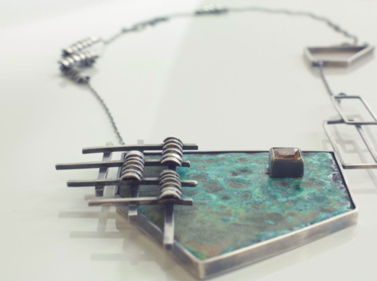 An industrial looking silver necklace designed by one of our students