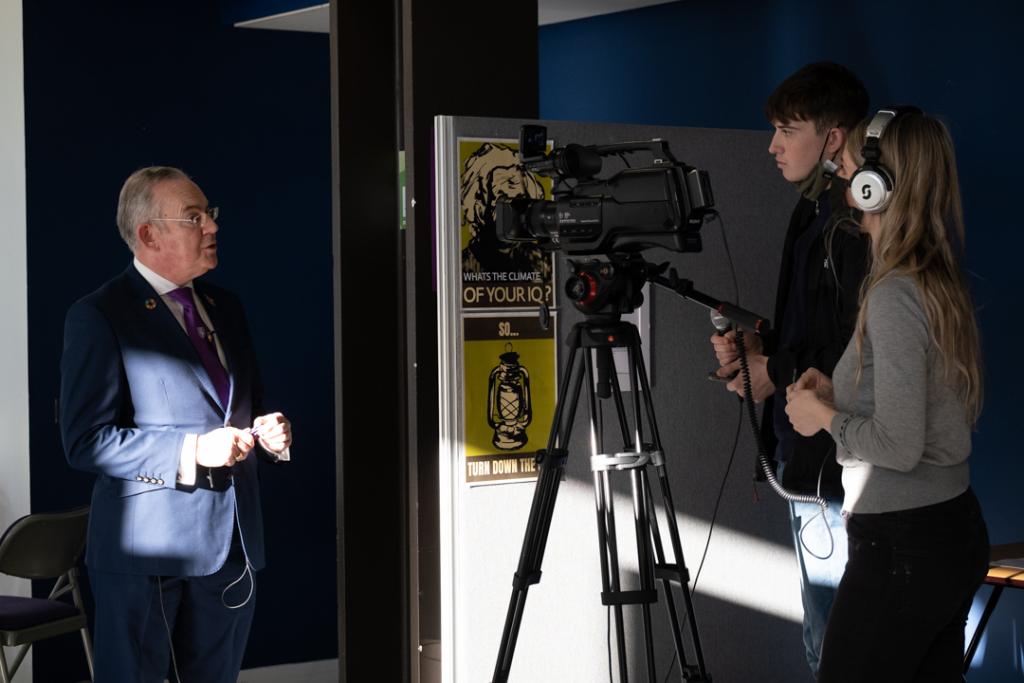 TV students filming Principal Paul Little.
