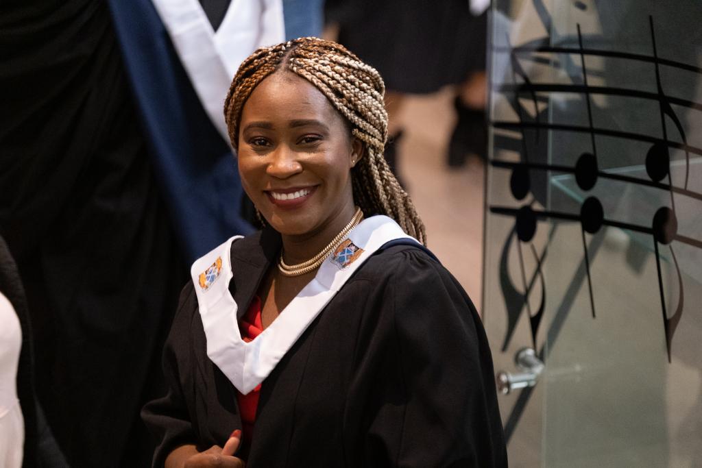 Student in the Royal Concert Hall wearing academic robes ready for Graduation