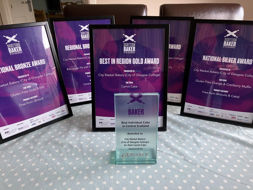 A close up of the Scottish Baker Award certificates and trophy