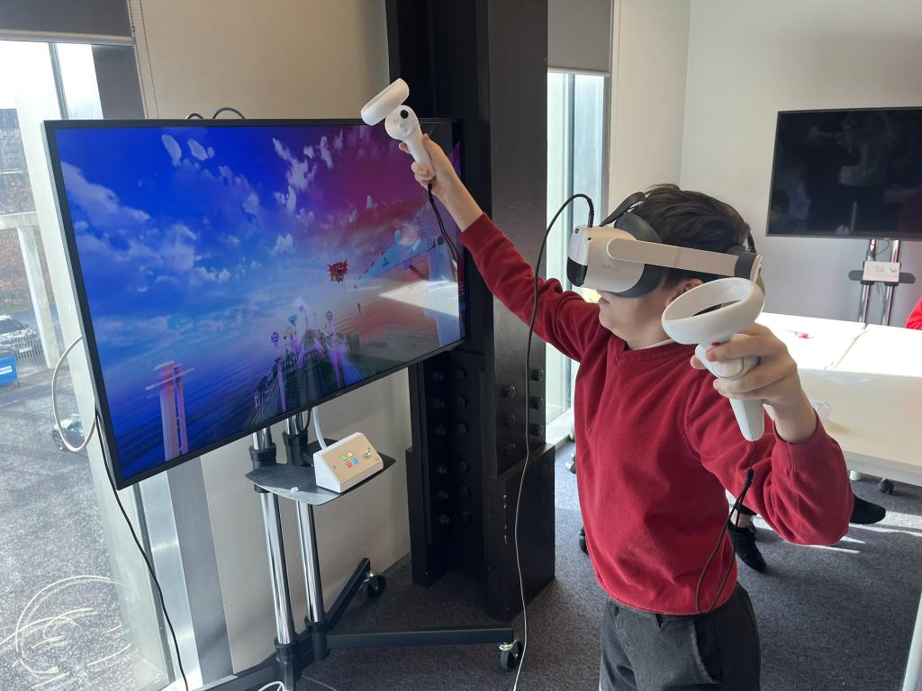 A primary school pupil tries out the VR headset.