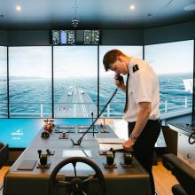 A nautical student using the nautical simulators at Riverside campus