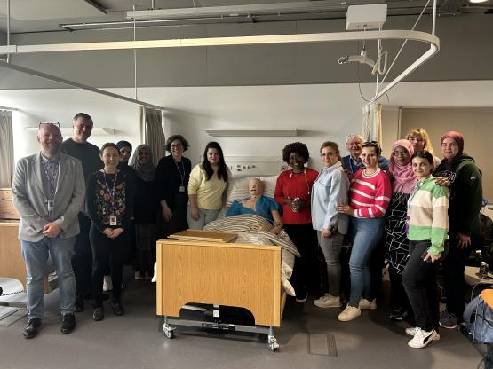 James Davies, AD ESOL and Communities, Morag McIntosh, ESOL Lecturer, Karen McIntyre, CEO The Bridges Programmes, and Dr David Ritchie, The Bridges Programmes pose for picture with students.