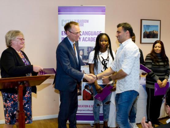 ESOL Students Celebrate Awards Triumph Minister for Learning, Science and Scotland’s Languages, Dr. Alasdair Allan MSP presenting awards to ESOL students