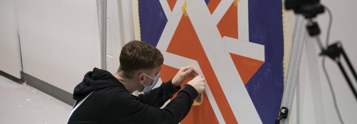 A student working on wall tiles at a WorldSkills competition