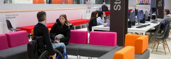 Student Advisor and student chatting in the Student Services area at City campus.