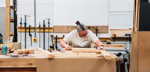 Student building a door in the carpentry workshop