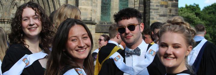 Students in graduation gowns outside Glasgow Cathedral
