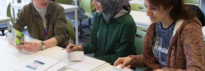 Lecturer and student chatting in classroom at City campus.