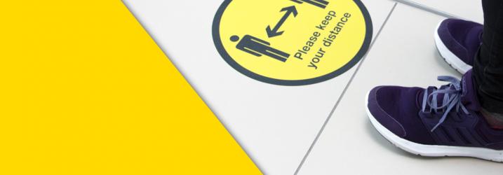 Please keep your distance social distancing sign on floor of campus. Please keep your distance social distancing sign on floor of campus.