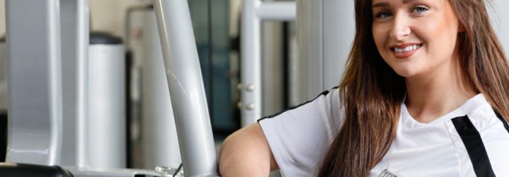 Student next to gym equipment