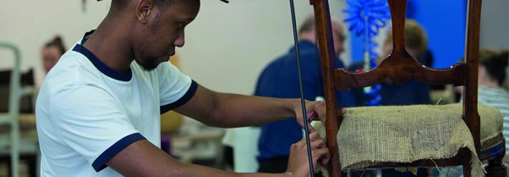 Creative industries student working on a piece of furniture.