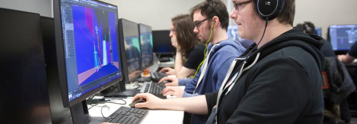 Students working on a computer in an IT lab.