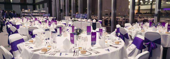 Tables set up and dressed for a formal event.