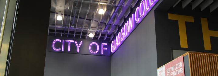 A close up of a purple neon sign saying City of Glasgow College