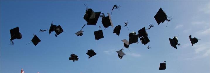Alumni Association Graduation hats in the air